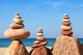 Rock zen pyramid of colorful pebbles on a beach on the background of the sea. Concept of balance, harmony and meditation Royalty Free Stock Photo