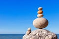 Rock zen pyramid of colorful pebbles on a beach on the background of the sea. Concept of balance, harmony and meditation Royalty Free Stock Photo