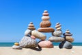 Rock zen pyramid of colorful pebbles on a sandy beach on the background of the sea. Concept of balance, harmony and meditation Royalty Free Stock Photo