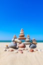 Rock zen pyramid of colorful pebbles on a sandy beach on the background of the sea. Concept of balance, harmony and meditation Royalty Free Stock Photo