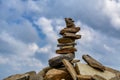 Rock zen pyramid of pebbles on a peak of mountain Rila on the background of cloudy sky. Concept of balance, harmony and meditation