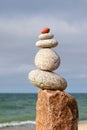 Rock zen pyramid of white pebbles on the background of the sea. Concept of balance, harmony and meditation Royalty Free Stock Photo