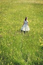 Rockabilly Girl with a white petticoat dress walking through a w