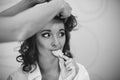 Morning of the bride. Makeup and hair stile. Bride eating biscuits. Black and wight