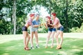 Group of friends at park having fun party. Cheerful girls with a cakes in hands. Retro style.