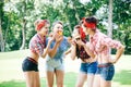 Group of friends at park having fun party. Cheerful girls with a cakes in hands. Retro style. Royalty Free Stock Photo