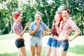 Group of friends at park having fun party. Cheerful girls with a cakes in hands. Retro style. Royalty Free Stock Photo