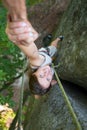 Rockclimber helping to female climber to reach top of mountain Royalty Free Stock Photo