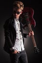 Rocker holding his guitar on shoulder and looking back Royalty Free Stock Photo