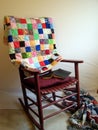 Rocker, antique quilt. Reading book. Royalty Free Stock Photo