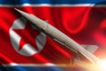 Rocket against the background Flag of North Korea. Royalty Free Stock Photo