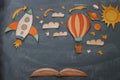 Rocket and air balloon cut from paper and painted over class room blackboard background.