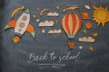 Rocket and air balloon cut from paper and painted over class room blackboard background.