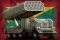 Rocket artillery, missile launcher with grey camouflage on the Grenada national flag background. 3d Illustration