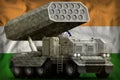 Rocket artillery, missile launcher with grey camouflage on the India national flag background. 3d Illustration
