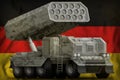 Rocket artillery, missile launcher with grey pixel camouflage on the Germany national flag background. 3d Illustration