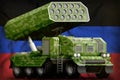 Rocket artillery, missile launcher with pixel green camouflage on the Donetsk Peoples Republic national flag background. 3d Illust