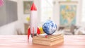Rocket and Earth Globe on Books in Bright Classroom Setting 3d render Royalty Free Stock Photo