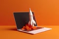 Rocket flying out of laptop screen on orange background. Startup concept Royalty Free Stock Photo