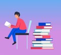 Young man sitting on chair reading book, pile of books Royalty Free Stock Photo