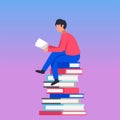 Young man sitting on books reading book, pile of books Royalty Free Stock Photo