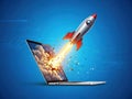 Rocket launch from laptop screen isolated on white background Royalty Free Stock Photo