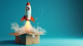 Rocket launching from a cardboard box on a blue background. Innovation and startup concept Royalty Free Stock Photo