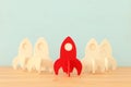 rocket leadership concept. red rocket as leader of the group. idea of standing out of the crowd Royalty Free Stock Photo