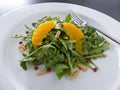Rocket salad with orange, pepper and pine nuts Royalty Free Stock Photo
