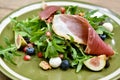 Rocket salad with prosciutto parma ham and berries fruit, Healthy diet food full of good vegetable and nutrition