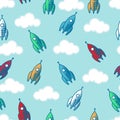 Rocket seamless pattern. Rocket start background. Red, blue, white, red rockets and clouds on light-blue background.