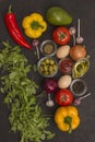 Rocket and spinach, eggs and tomatoes, yellow and red peppers, garlic, olives on a black background Royalty Free Stock Photo