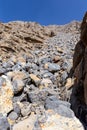 Rockfall and sliding stones seen from a hiking trail to Jabel Jais peak in Hajar Mountains, United Arab Emirates