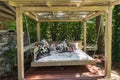 Rocking bed pergola. Garden bed with pillows