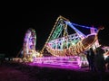 Rocking boat rides at the night festival with beautiful colors from the lights