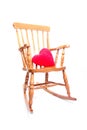 Rocking chair with red heart pillow Royalty Free Stock Photo