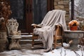 rocking chair on a snowy patio with a cozy throw draped over it