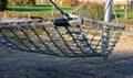 Rocking chairs made of ropes tied with ropes and chains in the park on the playground. tense between the two-column pillars. there