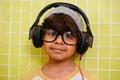 Rocking his own style. a cute little boy wearing a beanie and headphones. Royalty Free Stock Photo