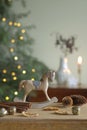 Rocking horse, horse bells, cones and cinnamon as a table decoration for Christmas Royalty Free Stock Photo