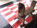 Rocking horse on red,white and black tile