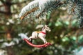 Rocking horse and snowy pine tree decorated for Christmas toy Royalty Free Stock Photo