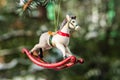 Rocking horse and snowy pine tree decorated for Christmas Royalty Free Stock Photo