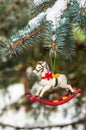 Rocking horse and snowy pine tree decorated for Christmas Royalty Free Stock Photo