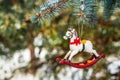 Rocking horse and snowy pine tree decorated for Christmas Royalty Free Stock Photo