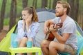 Rockman playing guitar and bored woman Royalty Free Stock Photo