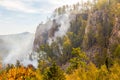 Rocks of Aigir in the smoke of a forest fire. Royalty Free Stock Photo