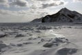 The rocks along the shore of a frozen sea