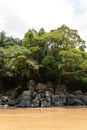 Rocks, amazonian river, boats and jungle in the area of colombian amazon Royalty Free Stock Photo