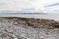 Rocks and beach with Cliffs of Moher in background in Inisheer island